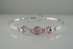 This dainty attractive bangle bracelet is handmade with Rose Swarovski Crystal and is wire wrapped with .925 argentium sterling silver wire. To get the perfect fit, measure your wrist and add one half inch. Copper Wire Crafts, Bijoux Fil Aluminium, Swarovski Bracelet, Crystal Bangle, Wrapped Jewelry, Wire Wrapped Jewelry, Silver Wire, Wire Jewelry, Beautiful Bracelet