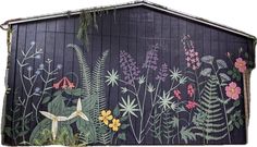 an image of a mural on the side of a building that has flowers and plants painted on it