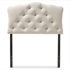 an upholstered headboard with metal legs and buttoned buttons on the back