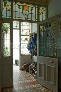 an entryway with stained glass windows and doors