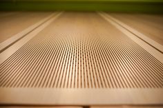 a close up view of the surface of a wooden floor with vertical lines on it