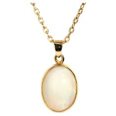 Crafted in 18 carat yellow gold, this adorable pendant features a lovely solid oval Australian crystal opal afire with alluring green and orange play of colour and set into an elegant milgrain rubover setting. Her name is The Cordy Pendant. She is threaded with an elegant cable chain and is ever-so-comfortable to wear, a perfect adornment fit for any time or place. The Cordy Pendant & Chain Gem Details The solid Australian white base opal display subdued flashes of orange and green play of colou