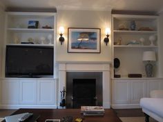 a living room filled with furniture and a flat screen tv mounted on the wall above a fireplace