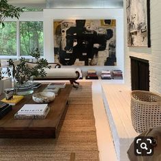 a living room filled with furniture and a dog sitting on top of a coffee table