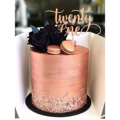 there is a pink cake with gold and black decorations on the top that says twenty one