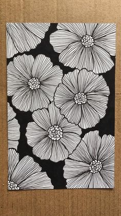 a black and white drawing of flowers on a cardboard box