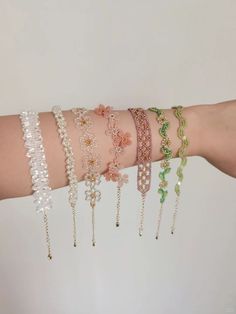 a woman's arm with several bracelets on it