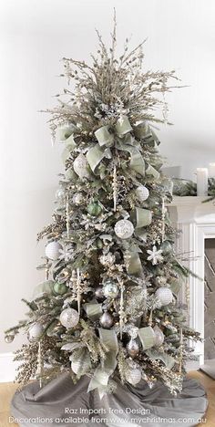 a decorated christmas tree with silver and white ornaments