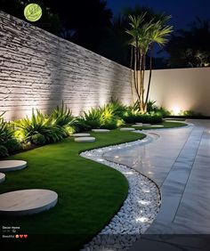 an outdoor garden with grass, rocks and lights