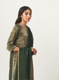 Editor's Note Featuring a zari striped kurta with silk salwar and plain dupatta with zari palla Color: Emerald Green Fabric: Kurta: Tissue; Dupatta: Chanderi; Pant: Cotton Silk Care: Dry Clean Only Luxury Raw Silk Salwar Kameez With Straight Kurta, Luxury Green Churidar With Printed Motifs, Luxury Green Cutdana Salwar Kameez, Luxury Green Kurta With Block Print, Luxury Green Chanderi Tops, Luxury Green Naqshi Salwar Kameez, Luxury Pista Green Raw Silk Salwar Kameez, Luxury Fitted Tussar Silk Churidar, Luxury Semi-stitched Tussar Silk Kurta