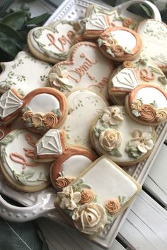 some decorated cookies are on a platter