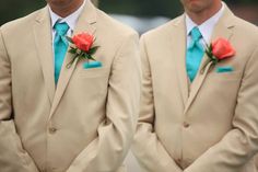 two men in tan suits with blue ties and red roses on their lapel flowers