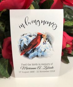 a close up of a greeting card with flowers in the background and a cardinal on it