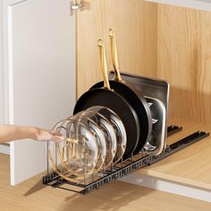 a person is reaching into the dish rack