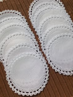 six white lace dois laid out on the floor