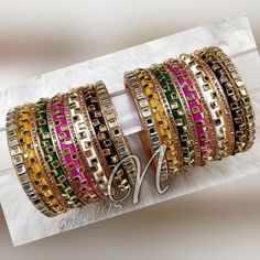 Make A Bold Statement With Unique Ensemble Assembled In Beautiful Color. Bangles Are Beaded With Zig Zag Pattern Glass Kundan. Stone Beaded Bangles Between Every Bangle Are Adding Charm To The Look. Box Shape Kundan Bangles At Both End Of This Chura Are Completing The Design. Feel The Moment Of Perfect Appreciation In This Exclusive Creation. This is a set of 22 Bangles (11 For Each Hand). Multicolor Embroidered Jewelry For Diwali, Bollywood Embroidered Jewelry For Party, Bollywood Embroidered Party Jewelry, Bollywood Style Embroidered Party Jewelry, Embroidered Festive Jewelry For Parties, Pink Embroidered Wedding Jewelry, Multicolor Dori Work Jewelry For Party, Eid Bangles, Wedding Chura