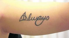 a woman's arm with the word always written on it and an arrow in cursive font