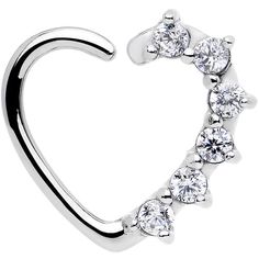 a heart shaped nose ring with five stones on the bottom and an attached bar in the middle