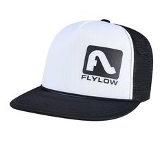 the flylow trucker hat in white and black is shown on a white background