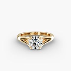 a yellow gold ring with a single diamond