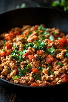 Ground meat cooked with diced tomatoes and fresh herbs in a black skillet. Ground Chicken Quinoa Recipes, Chicken Ground Recipes, Ground Chicken Instant Pot Recipes, Ground Chicken Recipes For Dinner Healthy, Crockpot Ground Chicken Recipes, Ground Chicken And Rice Recipes, Ground Chicken Breast Recipes, Ground Chicken Dinner, Recipes With Ground Chicken