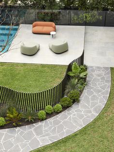 an aerial view of a backyard with a pool and lounge chairs on the grass area