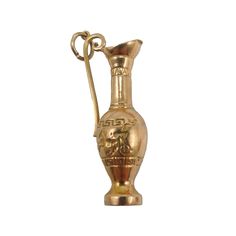 a gold colored vase with a handle on it