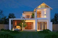 a car is parked in front of a modern house at night with its lights on