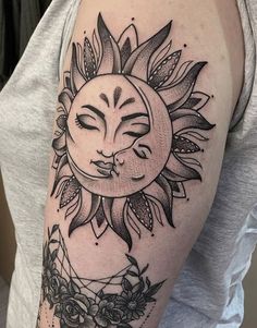 a woman's arm with a sun and moon tattoo on the left side of her arm