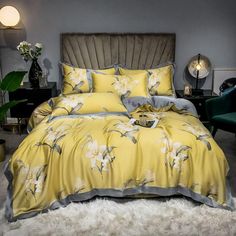 a bed with yellow and grey comforters in a room