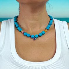 This handmade necklace is made of turquoise natural stone, glass and various beads. The necklace length is approximately 40 cm. My designs are unique like every woman. That's why I only make one of each, I'm sure you will enjoy wearing them as much as I do. Please do not hesitate to contact me for any questions. Colorful Beads Turquoise Necklace For Beach, Beach Turquoise Necklace With Round Beads, Blue Gemstone Beads For Festival, Blue Gemstone Beads For Festivals, Blue Gemstone Festival Beads, Blue Wooden Beads For Festival, Turquoise Beaded Necklaces With Natural Stones For Beach, Turquoise Jewelry With Wooden Beads For The Beach, Blue Wooden Beads Jewelry For Healing