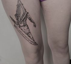 a woman's thigh with a tattoo of a man holding a surfboard on it