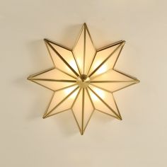 a star shaped light fixture on the wall