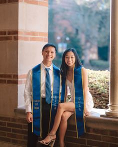 a man and woman in graduation gowns posing for a photo