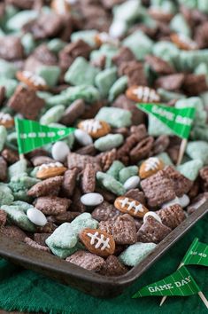 a bowl filled with green and white candies on top of a green table cloth