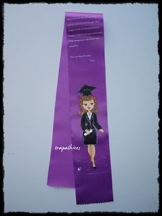 a purple bookmark with a girl wearing a graduation cap and gown