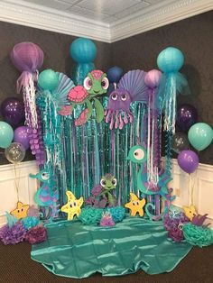 an under the sea themed birthday party with balloons, streamers and paper cutouts