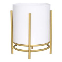 a white and gold planter sitting on top of a table