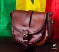 This bag was hand made by women in Ghana. The material is real leather, sourced locally from the Northern region of Ghana. It is very durable and easy to move with and can fit every style and occasion Traditional Leather Saddle Bag For Everyday Use, Traditional Leather Satchel With Adjustable Strap, Traditional Leather Saddle Bag With Adjustable Strap, Traditional Shoulder Bag With Leather Lining, Traditional Leather Crossbody Satchel, Traditional Brown Leather Saddle Bag, Traditional Leather Crossbody Shoulder Bag, Traditional Brown Soft Leather Bag, Traditional Bags With Leather Backing For Everyday Use