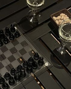 a chess board and some wine glasses on a table