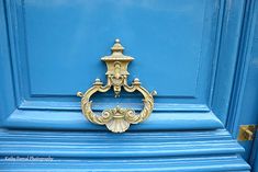 a blue door with a gold handle on it