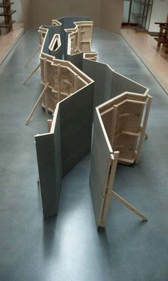 several pieces of wood sitting on top of a floor in an empty room with chairs