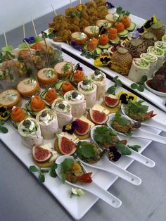 an assortment of appetizers are displayed on trays