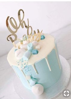 a blue and white cake sitting on top of a table