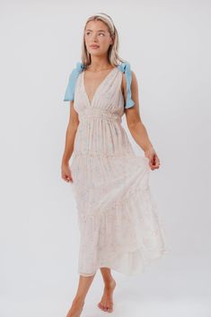 This little number perfectly blends gorgeous pink floral with a pop of bright blue -- meet the Lucille Maxi Dress! This gorgeous gown is feminine and floral, with a stretchy empire waist and multi-tiered skirt. We love its ruffle accents and self-tie shoulder straps in a stunning shade of blue. Pair it with neutral heels for a baby shower or garden party! FIT: Runs true to size. MATERIAL: 100% Polyester. GARMENT DETAILS: Sleeveless, lightweight chiffon maxi with plunging V-neckline, gathered emp Neutral Heels, Strap Maxi Dress, Garment Details, Chiffon Maxi, Gorgeous Gowns, Tiered Skirt, Bright Blue, Empire Waist, Garden Party