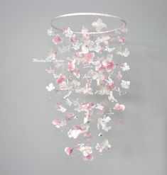 a white and pink wind chime with butterflies on it