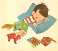 a young boy laying on top of a bed next to an open book and red shoes