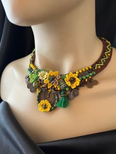 a mannequin wearing a necklace with sunflowers and other items on it