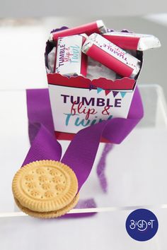 a cookie and candy bar wrapped in purple ribbon