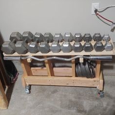 an assembly table with several dumbs on it and some wires hanging from the wall